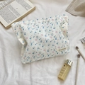 Detailed macro shot of floral lace cosmetic bag with delicate fabric texture and patterns - Jacquard Blue Cherry
