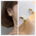 Minimalist gold hoop earrings with Roman numeral cutouts shown on a model and card - Gold Roman Numerals Ear Buckle