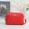 Chic red quilted crossbody bag with gold chain strap and metallic plaque detail - Red