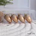 Set of four gold acorn Christmas ornaments with snow glitter finish and hanging loops - Gold Pinecone (Pack of 4)