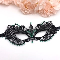 Elegant black lace masquerade mask with green rhinestones and ribbon ties on white base - Black With Green Rhinestone