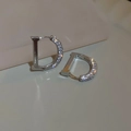 Macro shot of silver letter D earrings with sparkling zircon pave setting on grey surface - Silver D Letter Ear Buckle (12#)