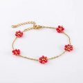 Detail of gold chain bracelet with five red beaded flowers and adjustable lobster clasp - Light Red