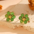 Detailed close-up of floral stud earrings with green cat-eye stones and golden finish - Gold Green Cat's Eye Stud Earrings