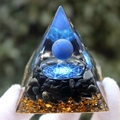 Orgonite energy pyramid with blue sphere and gold flakes shown in gloved hands - Lapis Lazuli White Ball Magic Circle / Small