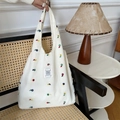 Detailed close-up of white canvas tote bag featuring colorful floral embroidery - Apricot Full Small Floral