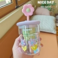 Close-up of glass bottle with flower prints, purple lid and pink 3D floral straw detail - 500ml / Purple