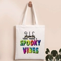 Detail of Halloween pumpkin tote bag featuring Thick Thighs Spooky Vibes text and cats - Three Black Cats