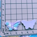 Purple butterfly resin charms for DIY crafts and shoe accessories on a measuring mat - Purple