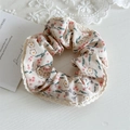 Detailed view of floral hair scrunchie with pink blossoms and white lace trim edge - Off-white With Lace Edge