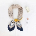 Silk-feel square scarf with yellow and navy feather print tied in a stylish knot - Blue Border Color Block