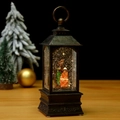 Close-up of vintage bronze Christmas lantern with illuminated Nativity Scene and snow - Nativity Scene