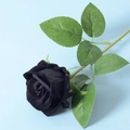 Elegant single black velvet artificial rose with green stem on light blue background - Black