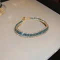 Brazalete dorado de tres filas con circonitas azules y blancas de estilo vintage - Estilo 10 Pulsera