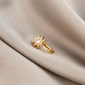 Detailed close-up of a gold U-shaped non-piercing star nose clip with micro-set zircon - Snowflake (E5689-8)