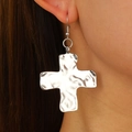 Silver snail-textured cross earrings with hammered finish shown on female model - Silver Earrings (Wrinkled Cross 7126)