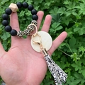 Detail of silicone beaded keychain with leopard print, leather tassel and round wood charm - Black Leopard Print (Style 7)