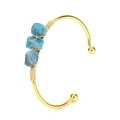Detailed view of handmade gold cuff bangle with blue raw stone and wire wrapped crystals - Grey Apatite