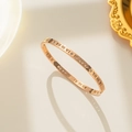 Rose gold Roman numeral bangle with rhinestones on an elegant mirrored background - Rose Gold