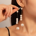 Detail of elegant gold tassel earrings with cascading white faux pearls on model - Style 14-White Pearl Tassel Drop Earrings (Silver Earring Post)