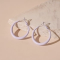 Detailed close-up of light purple hoop earrings on textured stone over beige background - Silver Needle Small Hoop / Purple