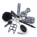 Detail of multi-functional keychain kit including zebra print wristlet and black accessories - Black White Zebra