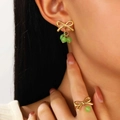 Golden bow jewelry set with green beads including a ring and earring worn by a model - Green Bead Earrings & Ring Set