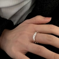 Adjustable silver irregular wavy ring with black zircon stone on model hand - No. 33 Open Ring