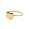 Detailed macro view of yellow peach alloy napkin ring with green leaves on white background - Peach