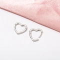 Minimalist silver heart-shaped hoop earrings on elegant pink silk background - Heart / White Gold
