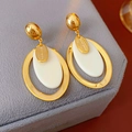 Detailed close-up of oval gold-plated resin earrings with Hand Made engraving in a gift box - White Oval Pendant Style / White