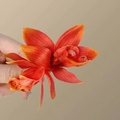 Vibrant orange faux orchid hair clip with realistic petal textures and center details - Red Cymbidium