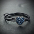Elastic hair tie with a blue rhinestone heart pendant on a black leather background - Blue Heart