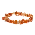Close-up of handmade irregular orange crystal stone beads on a minimalist bracelet - Orange Jade