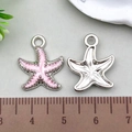 Pink glitter starfish pendant in silver alloy finish with measuring ruler showing size - Pink Glitter Starfish 15x19mm