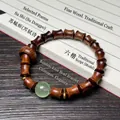 Pulsera de sándalo en forma de bambú con gema verde y separadores dorados - Palo de Rosa Negro Estilo Bambú con Cuenta Luminosa