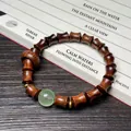 Pulsera de sándalo en forma de bambú con gema verde y separadores dorados - Palo de Rosa Negro Estilo Bambú con Cuenta Luminosa