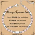 Close-up of handmade 4mm pink zebra stone beaded bracelet on a kraft paper gift card - Always Card Style / With Card / Rose Quartz