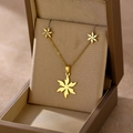 Detailed view of golden leaf-shaped necklace and stud earrings set in a brown jewelry box - Leaf Shape (TZ-412)