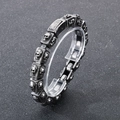 Macro shot of retro stainless steel square links with skull relief on a man's bracelet - Steel Color (KB179298-KJX)
