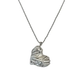 Macro view of vintage heart pendant featuring 18k gold plated wave texture surface - Necklace / Silver