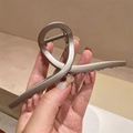 Detail of a matte champagne gold metal hair claw clip with a minimalist cross design - Matte Champagne Gold (FJ3799)