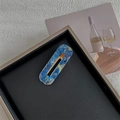 Close-up of a blue marble texture vintage hair clip on a black decorative tray - Map Dark Blue Hollow Rectangular