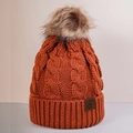 Detail of cable knit beanie with faux fur pom pom and leather logo patch in orange - One Size / Caramel color