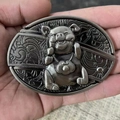 Detailed view of silver-tone pig head belt buckle with traditional lock charm - Zodiac Pig
