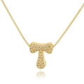 Macro shot of gold-plated letter T pendant encrusted with pavé zircons on a box chain - Letter T