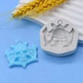 Macro detail of silicone mold with bat-winged skull and finished blue pendant - Bat Winged Skull Style (5)