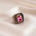 Detail of pink rectangular gemstone and white diamonds on brown resin geometric ring - Black and Rose