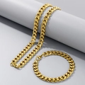 Golden Miami Cuban chain necklace and bracelet set displayed on a grey pedestal - 9mm Gold / Bracelet 20CM