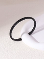 Detailed macro shot of the black woven texture on the stainless steel cuff bracelet - Black